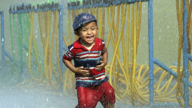 A little boy is splashed with water during the opening ceremony of the annual Thingyan water festival celebrations in Yangon.