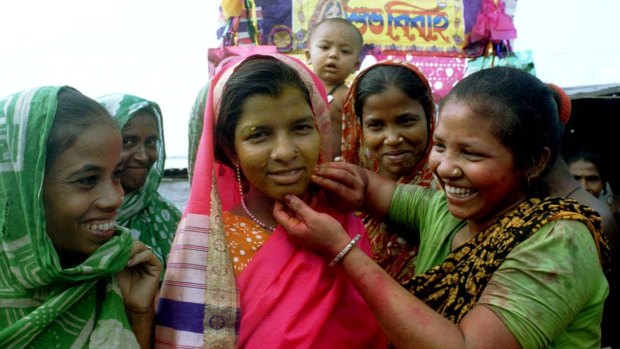 Village girls prepare a young bride (centre) for her wedding near the Bangladesh capital of Dhaka.