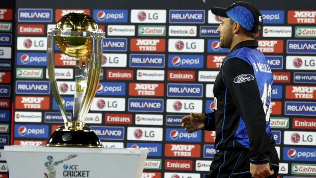 Not this year: Brendon McCullum, named in the ICC team of the tournament, walks past the Cricket World Cup trophy after losing the final against Australia.