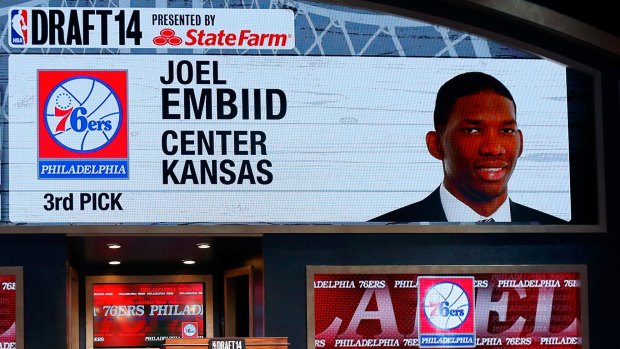 Unseen potential: A video screen shows the selection of Joel Embiid of Kansas as the #3 overall pick in the first round by the Philadelphia 76ers during the 2014 NBA Draft at Barclays Center on June 26, 2014.