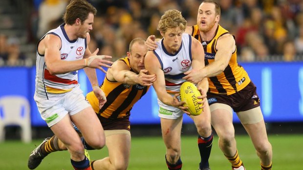 Hawthorn's David Hale and Jarryd Roughead team up to tackle Adelaide's Rory Sloane. 