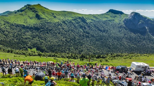 The peloton riding on the road to Pas de Pyerol, Cantal in the Central Massif.