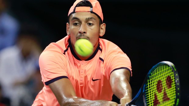 Nick Kyrgios of Australia returns a shot to David Goffin of Belgium at the Japan Open final.
