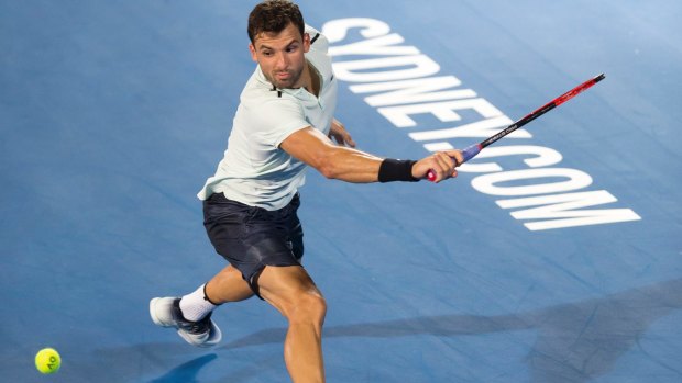 Grigor Dimitrov returns the serve of Lleyton Hewitt during the Fast Fours exhibition match at the Sydney International on Monday.