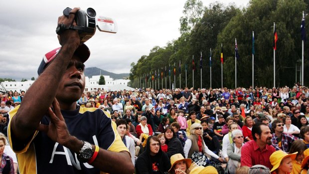 Thousands of people watch TV screens on the Parliament lawns as Australian prime minister Kevin Rudd delivers the apology.