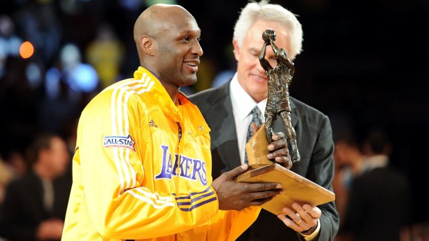 Talented player: Lamar Odom of the Los Angeles Lakers receives the Six Man of the Year Award from Lakers general manager Mitch Kupchak before game two of the 2011 Western Conference playoff series.