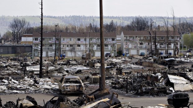 The charred remains of houses and vehicles litter the neighbourhood of Abasand in wildfire-ravaged Fort McMurray.