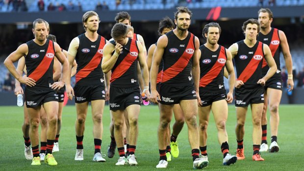 The Bombers make their way from the ground after the Round 15 AFL match between the Essendon Bombers and Brisbane Lions at Etihad Stadium. 