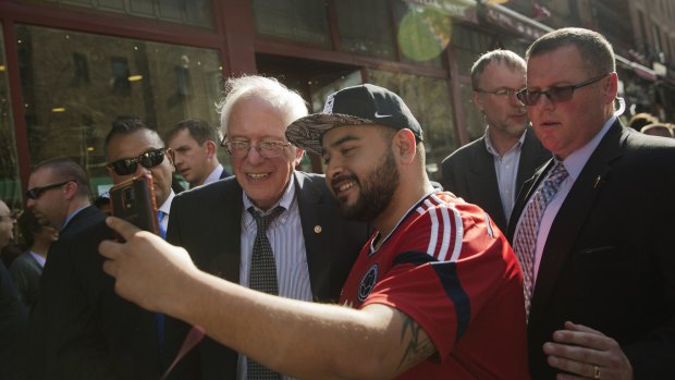 Senator Bernie Sanders, an independent from Vermont and 2016 Democratic presidential candidate, centre, poses for a selfie  in Queens, New York.