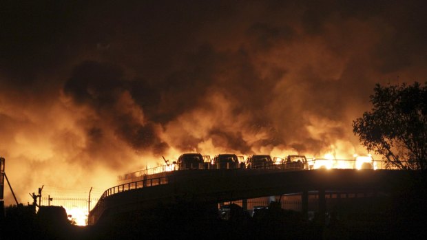 Vehicles burn in Tianjin.