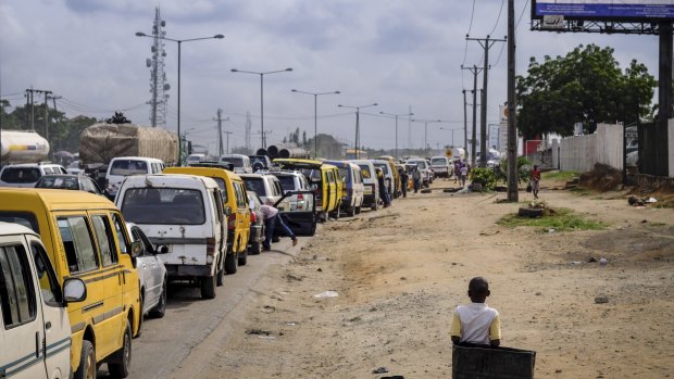 Drivers wait in line for fuel at Oando Petrol Station in Lagos, Nigeria.