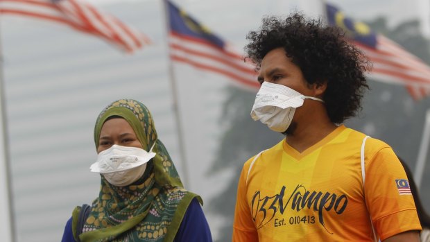 A Malaysian in a face mask on Sunday, as the haze from forest fires worsens across south-east Asia.