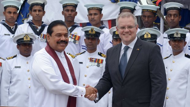 Then Sri Lankan president Mahinda Rajapaksa, left, shakes hands with then immigration minister Scott Morrison in Colombo in July of last year, after formally commissioning two Australian-gifted naval patrol boats.
