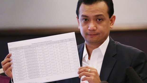 Philippine senator and vice presidential candidate Antonio Trillanes IV shows alleged joint bank account records by presidential candidate Rodrigo Duterte and his daughter Sara at a foreign correspondents forum on Tuesday.