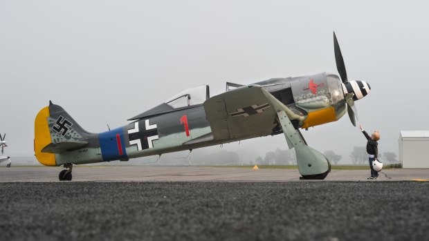 James Lane, 5, of Thurgoona, Albury, inspects the Focke-Wulf ahead of next weekend's Wings Over Illawarra air show.