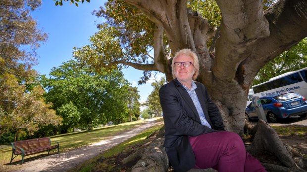 Dave Kendal under a Morton Bay Fig tree, a species which could become more abundant in a warmer Melbourne. 