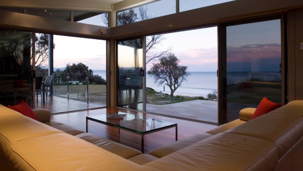 At Coast@Culburra steel frames and corrugated iron exteriors across three levels blend with several decks and large windows on the ocean side of the main living area.