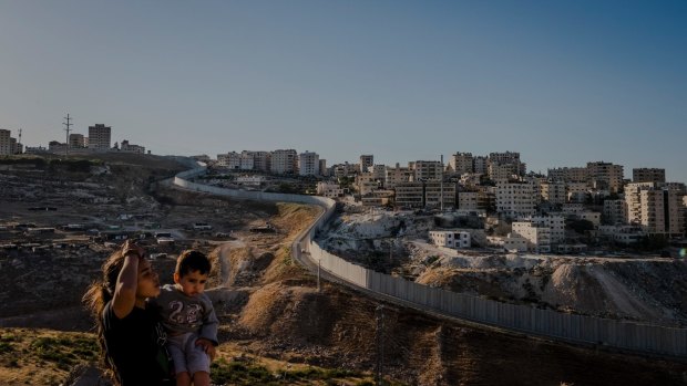 The separation wall snakes around Shuafat in occupied East Jerusalem. Here as in Kufr Aqab further north, the wall's route has created anomalous living conditions for Palestinians.