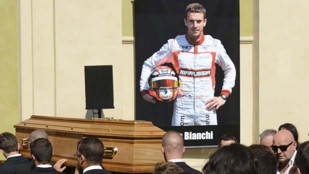 Pallbearers carry the coffin of late Marussia Formula One driver Jules Bianchi followed by family members and his father Philippe Bianchi (right) before the funeral ceremony at the Sainte-Reparate Cathedral in Nice, France.