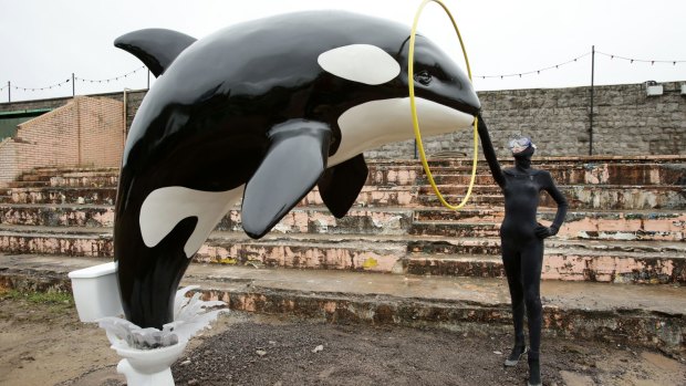 A Banksy piece depicting an orca whale jumping out of a toilet is displayed at Banksy's biggest show to date, Dismaland, in Weston-Super-Mare, near Bristol.