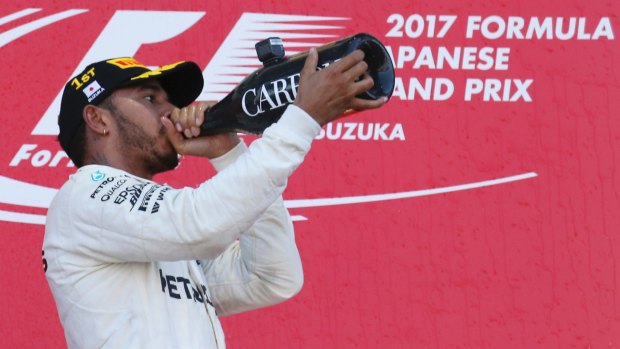 Champagne showers: Lewis Hamilton celebrates a win and essentially locking in the title.