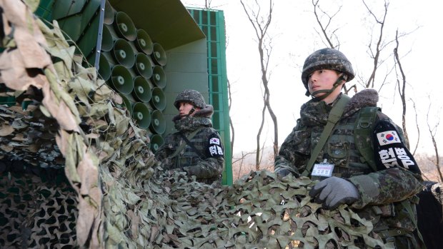 South Korean army soldiers remove camouflage from the loudspeakers near the border to resume broadcasts of anti-Pyongyang propaganda.
