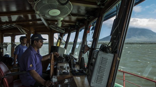 Captain Modesto Espinosa navigates a ferry full of cargo and passengers across Lake Nicaragua in February. Nicaragua's history is littered with dozens of failed canal schemes.