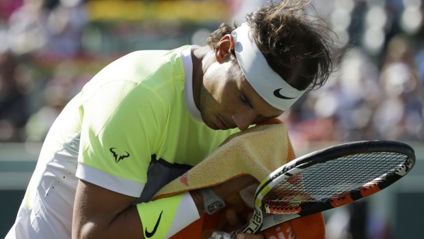 Rafael Nadal wipes the sweat from his brow during his match against Fernando Verdasco.