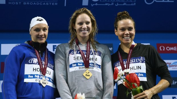 Katinka Hosszu of Hungary, Emily Seebohm of Australia and Natalie Coughlin of the USA stand on the podium after the Women's 100m Backstroke final.