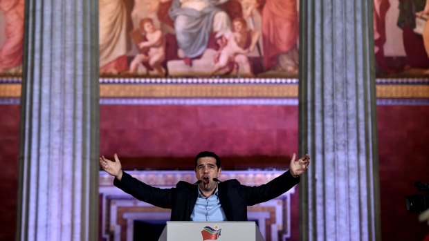 Syriza leader Alexis Tsipras hails his party's victory outside Athens University on Sunday night.