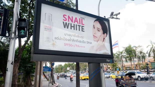 Skin whitening products advertised in Bangkok.