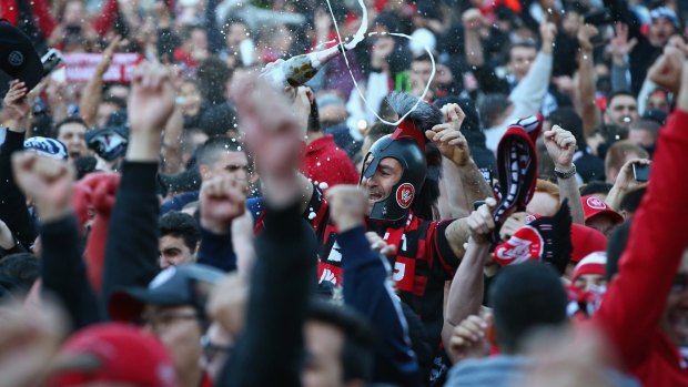 Jubilation: Wanderers fans celebrate the victory at Parramatta.