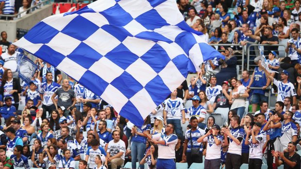 Happy bunch this Good Friday: Bulldogs supporters cheer during the round four NRL match between the South Sydney Rabbitohs and the Canterbury Bulldogs at ANZ Stadium.