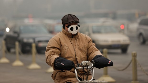 Riding a pushbike through the smog in Beijing last year. 