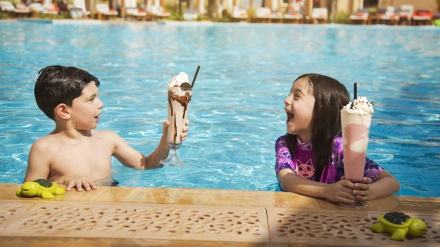 Kids enjoy mega milkshakes at the poolside cafe. 