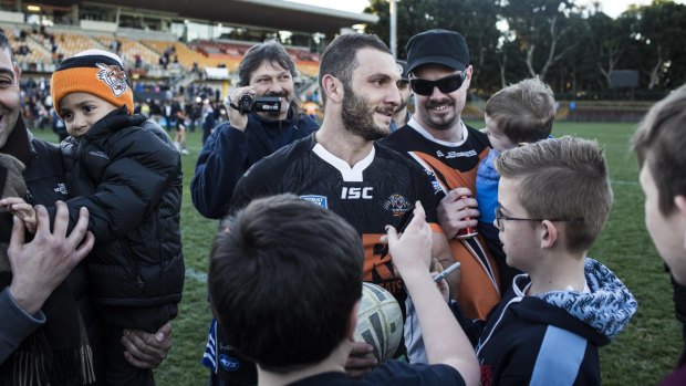Mobbed: Tigers hooker Robbie Farah is cheered as he walks off Leichhardt Oval on Saturday.