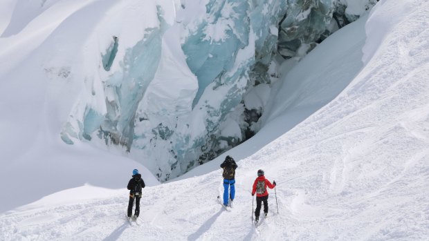 Skiers admiring the ice forms on the walls of the Vallee Blanche.