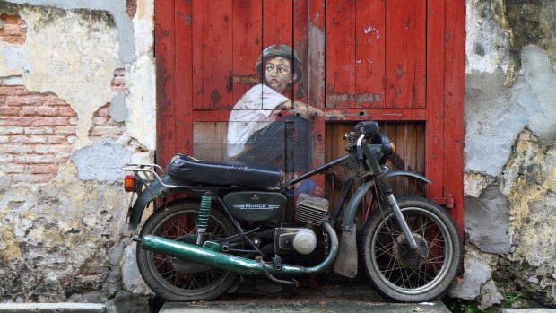 Street art Boy On Bike by Ernest Zacharevic.