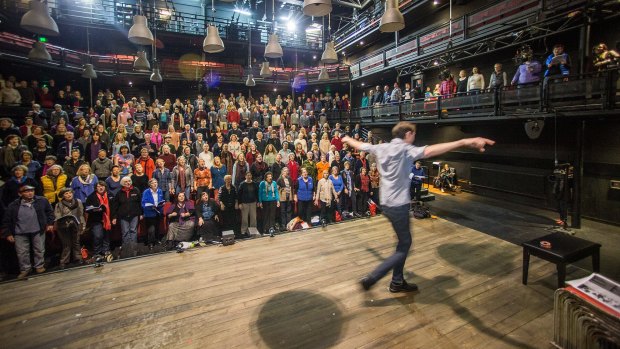 Musical director Luke Byrne leads a 'super rehearsal' for The Events with 300 singers from 10 different choirs at the Malthouse Theatre.