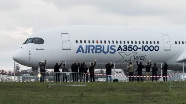 The A350-1000 twinjet passenger plane stands on the tarmac following its first flight at the Airbus factory in Toulouse, France.