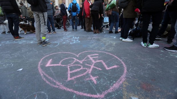 Love BXL written on the ground as people leave tributes at the Place de la Bourse in Brussels. 