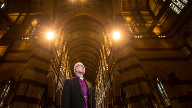 Anglican Archbishop Dr Philip Freier in St Paul's Cathedral after the church's 350 lights were replaced with energy-efficient bulbs to cut emissions and save power.