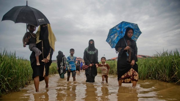 Rohingya Muslims, who crossed over from Myanmar into Bangladesh, walk to the Jamtoli refugee camp in Ukhiya, Bangladesh last week.