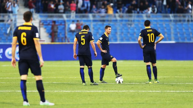 Waiting to restart: Australian players look dejected during the World Cup qualification match between Jordan and Australia at Amman International Stadium.