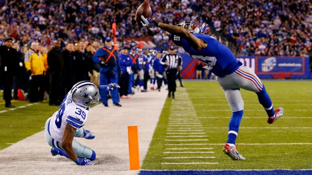 What a catch: New York Giants wide receiver Odell Beckham scores a touchdown against Brandon Carr of the Dallas Cowboys at MetLife Stadium on November 23, 2014.
