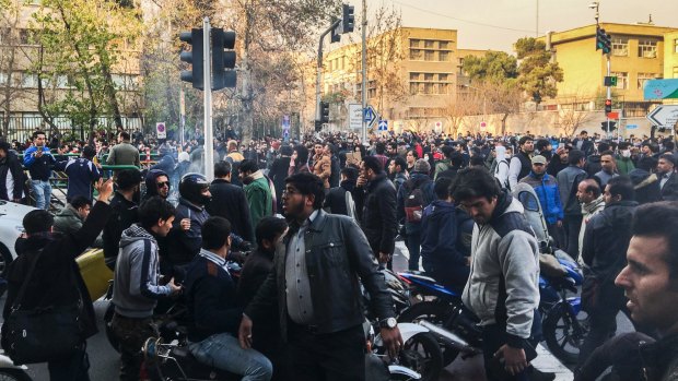 In this photo taken by an individual not employed by the Associated Press, demonstrators gather to protest against Iran's weak economy in Tehran.