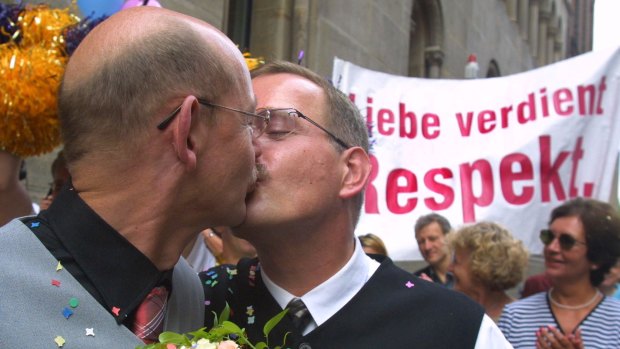 Heinz Friedrich Harre kisses his partner Reinhard Luechow in front of the registry office of Hanover, northern Germany, in August 2001.