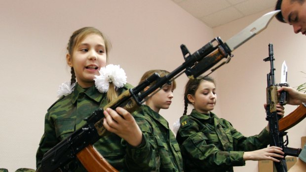 Girls learn to handle Kalashnikov assault rifles at the cadets' boarding school No. 9 for girls in Moscow.