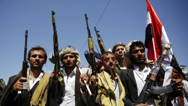 Shiite fighters, known as Houthis, brandish their weapons during a demonstration against the Saudi-led coalition in Sanaa, Yemen, on Sunday.