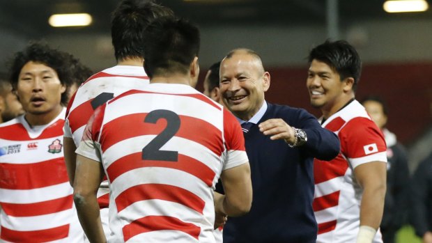 All smiles: Japan coach Eddie Jones talks with his players after the Rugby World Cup pool-B match between the US and Japan.